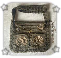 a crocheted purse with two buttons on the front and one in the back