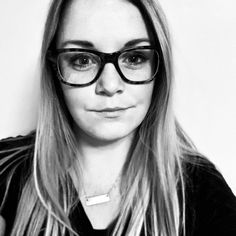 black and white photo of a woman wearing glasses