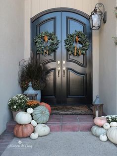 front door decorated with pumpkins and gourds