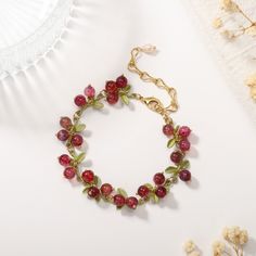 This Cranberry Agate Bracelet is the perfect accessory for the luxury-minded. From the stunning cranberry colour to the glossy agate stone, every element is carefully crafted for a sophisticated and exclusive look. Define your style with this timeless piece. DETAILS Plating: 18K Gold Materials: 18K Gold on Brass, Natural Stone Measurements: Length: 6.69"(17cm) + Extender: 2.76"(7.0cm) Weight: 15.43g There will be a little difference among different production batches of products due to the varia Elegant Red Agate Beaded Bracelets, Elegant Agate Beaded Bracelets For Gift, Elegant Red Agate Bracelets, Adjustable Ruby Bracelets Gift, Ruby Beaded Bracelets With Gemstone Beads As Gift, Gift Ruby Gemstone Beaded Bracelets, Elegant Handmade Red Charm Bracelet, Elegant Red Handmade Charm Bracelet, Ruby Beaded Bracelets As A Gift