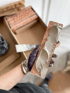 a person holding a piece of clay in their hand