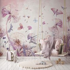 a room with pink and white flowers on the wall, a swing chair and rug