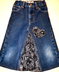 a women's denim skirt with an embroidered heart on the front and side pockets