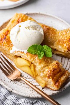 an apple pie on a plate with ice cream