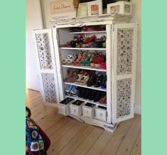 a white cabinet with many pairs of shoes in it