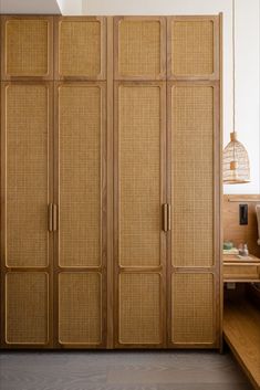 a room with some wooden furniture and wickers on the doors, in front of a window