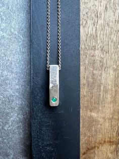 "Unique Silver Bar Textured Pendant Necklace For Men, Unique Emerald Silver Jewelry, Handmade by OmriGoren. This is a 925 sterling silver necklace and a hand-made textured silver bar pendant. A beautiful piece of raw emerald is held in a frame set as a centerpiece. This truly Unique Bar Necklace For Men is the perfect piece of jewelry for meaningful events Or everyday outfits, an art piece that cannot be ignored! My new unique men's jewelry collection combines metals and gemstones, creating a un Men’s Necklaces, Bar Necklace Men, Men Silver Jewelry, Unique Mens Necklace, Mens Pendant Necklace, Silver Necklace For Men, Pendant Necklace Men, Mens Necklace Pendant, Raw Emerald