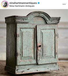 an old wooden cabinet is sitting on a table