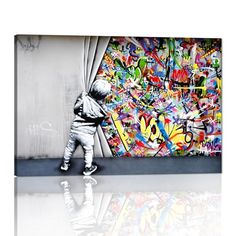 a little boy standing in front of a graffiti covered wall with his reflection on the floor