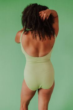 We love a textured one piece! Our custom scrunch one piece is sewn in the dreamiest textured fabric in citron green. Designed by the Pink Desert Design Team. A simple silhouette that is easy to wear, comfy, and super trendy, not to mention flattering! Pink Desert brand Scrunch fabric Scoop neck Supportive for busts A-DD Full bottom coverage Nursing friendly Floating shelf bra with soft, removable cups Fully lined front and back Self: 92% polyester, 8% spandex Lining: 92% polyester, 8% spandex Pr Textured Green Beachwear Swimwear, Green Textured Swimwear For Summer, Green Stretch Summer Bodysuit, Textured Green Swimwear For Summer, Green Textured Fitted Swimwear, Textured Green Swimwear For Poolside, Fitted Textured Green Swimwear, Green Ribbed Swimwear For The Beach, Green Ribbed Swimwear For Beach