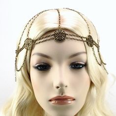 Maiden Wasila Headchain in Antique Bronze In a world that thrives on tradition and routine, the unexpected is sure to leave a lingering impression. The eye-catching Maiden Wasila headchain is an elegant and special touch to your Medieval or Renaissance era costume. This memorable Medieval headpiece features elegant floral medallions at each station along a network of fine antique bronze chain. Graceful chains drape from each station creating a flowing feminine look. See beyond a simple necklace Bohemian Gold Body Chain For Festivals, Gold Bohemian Body Chain For Festivals, Gold Bohemian Body Chain, Bohemian Gold Metal Body Chain, Bohemian Adjustable Metal Body Chain, Adjustable Metal Bohemian Body Chain, Adjustable Bohemian Metal Body Chain, Adjustable Festival Headband, Bohemian Adjustable Body Chain