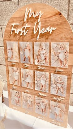 a baby's first year wooden sign with photos on it