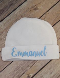 Personalized Baby Name Hat, shown on a baby blue hat with white non glitter writing and also shown on a white hat with baby blue writing. Perfect New Baby Gift, Suitable for a girl or a boy. Please state the color of writing you would like on the hat or it will be made as shown. If you would like a different color of lettering than pictured, please message me in the notes to seller upon checkout with your choice below: Glitter Colors: Black, Silver, Gold, Red, Blue, Purple, Lavender, Pink, Mint Baby Blue Hat, Personalized Baby Hat, Personalized Newborn, Glitter Colors, Newborn Baby Hats, Personalized Baby Girl, Lavender Pink, Newborn Hat