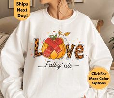 Get ready to fall in love with our "Love Fall Y'All" sweatshirt! Embrace the cozy spirit of autumn with this charming and trendy design. Crafted with care, our sweatshirt is made from soft and durable fabric, ensuring maximum comfort as you enjoy the cool breeze and changing leaves. The eye-catching "Love Fall Y'All" print adds a touch of seasonal charm, making it a perfect outfit choice for pumpkin patch visits, bonfire gatherings, or simply lounging with a hot cup of apple cider. Its relaxed f Trendy Heart Graphic Sweatshirt For Fall, Fall Cartoon Print Hooded Hoodie, Oversized Fall Sweatshirt With Character Print, Fall Character Print Relaxed Fit Sweatshirt, Fall Cat Print Hoodie Sweatshirt, Leopard Hoodie, Love Hoodie, Thanksgiving Sweatshirt, Cool Breeze