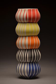 four striped vases stacked on top of each other