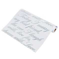 a roll of white wrapping paper with silver lettering on the top and bottom of it