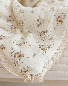 a white blanket with flowers on it