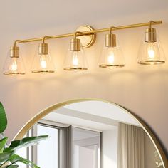 a bathroom vanity light with three lights and a mirror in front of the sink area