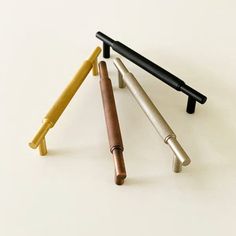 three different types of pens sitting next to each other on top of a white surface