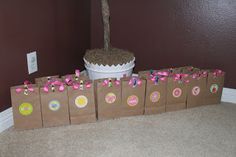 there are bags with donuts on them sitting in front of a cake and cupcakes