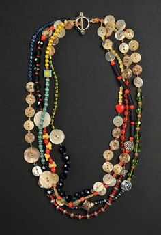 a multi - strand necklace with buttons and beads