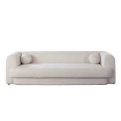 a white couch with two pillows on it