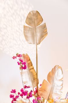 some pink flowers are in a vase on a table