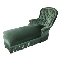 a green velvet chaise lounge with fringe trim