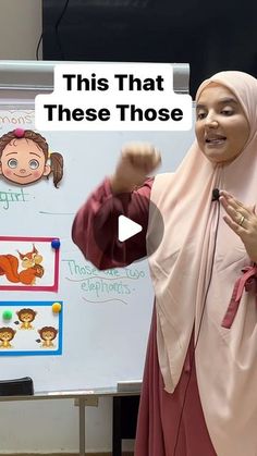 a woman standing in front of a whiteboard giving a speech to someone behind her