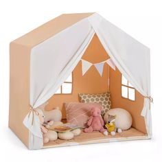 a toy tent with stuffed animals and pillows in front of the door to its room