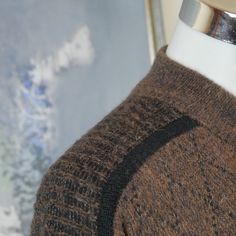 "This 1980s Italian vintage sweater is a warm brown color with a burgundy argyle pattern across the front and back and accented with black fine striping. The wool-mohair blend pullover has a short V neckline with a wide ribbed crossover collar. The sweater has ribbed cuffs and a ribbed waistband. Note that this is a \"short\" size. See especially the sleeve length and sweater length below. Brand label: Nani Bon Size: 46S (US/UK) Material: 40% acrylic, 30% wool, 20% mohair, 10% nylon Chest = 46 i Vintage Brown Sweater For Layering, Affordable Vintage Brown Sweater, Retro Brown Crew Neck Sweater, Retro Crew Neck Sweater With Argyle Pattern, Retro Brown Wool Sweater, Vintage Brown Sweater With Button Closure, Brown Argyle Sweater, Brown Argyle Long Sleeve Sweater, Pullover Sweater Men