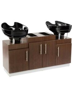 two black sinks sitting on top of wooden cabinets