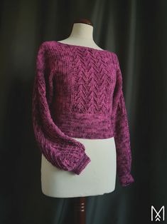 a mannequin with a purple sweater on it