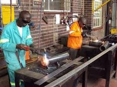 two men working on an assembly line in a factory