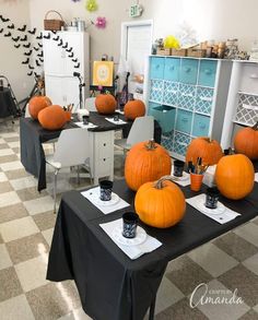 there are many pumpkins on the tables in this room