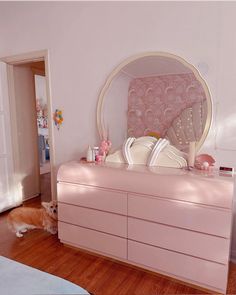 a dog laying on the floor next to a dresser