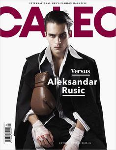 a man in black jacket and gloves on the cover of a magazine with red lettering