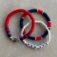 three red, white and blue bracelets with words on them