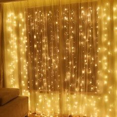 a living room filled with furniture and lots of lights on the curtains over the window