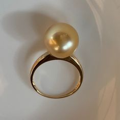 Stunning Big South Sea Golden Pearl Ring, 11.8mm, Bright Rich Gold Color, Very High Luster, Absolutely Stunning.   Solid 18k Yellow Gold, Very Well made and Comfortable to wear. US Size 7.5. Elegant and stunning. Something you can wear forever.  Classic and Elegant     Lustrous beauty  Pearl ★ Genuine South Sea Golden Pearl ★ Size: 11.8mm ★ Shape: Near Perfect Round ★Color: Natural Untreated, Bright Sunny Gold, Beautiful ★ Surface: Nice, Baby Smooth and Mirror Like, Mostly Very Clean, gentle texture not visible when wear Ring ★ Metal: Solid 18k Yellow Gold, Very Well made and Comfortable to wear ★ Size: US Size 7.5 Shipping FREE with USPS First Class in US. 14k Gold Pearl Ring With Polished Finish, High Luster Yellow Gold 14k Ring, 14k Yellow Gold High Luster Pearl Ring, Yellow Gold Pearl Ring With High Luster, Fine Jewelry Yellow Gold Pearl Ring With High Luster, Gold Pearl Ring Fine Jewelry With Polished Finish, Gold Pearl Ring With Polished Finish, Fine Jewelry Yellow Gold Rings, Fine Jewelry Gold Pearl Ring With Polished Finish