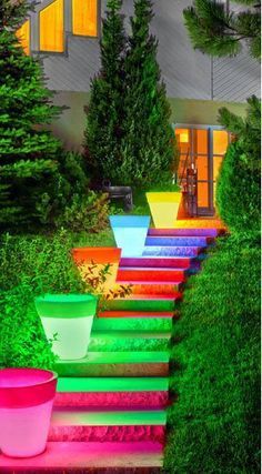 there are many different colored pots on the steps