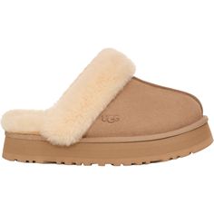 Looking for comfort without sacrificing style? Try the UGG Disquette, a platform slipper with super-soft cushioning, perfect for those early mornings when you need a cozy start. These UGG Disquette Sand Suede Women's Slippers have the following features: Suede Upper Sheepskin Collar and Lining 1" Platform Height EVA Midsole Woven Ugg Labeling Heat Embossed 1122550-SAN Ugh Slipper Platform, Uggs Slippers Platform, Ugh Disquette Slipper, Uggs Slides, Uggs Slippers, Athletic Sandals, Early Mornings, Wedge Loafers, Dress Loafers