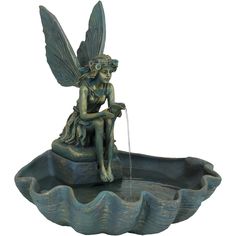 a water fountain with a fairy sitting on it's back and holding a faucet