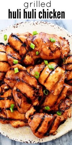 grilled chicken on a plate with green onions