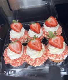 cupcakes with strawberries on top in a plastic container, ready to be eaten