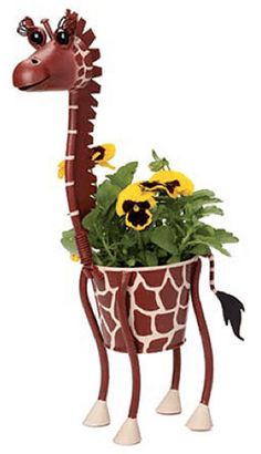 a giraffe planter with flowers in it