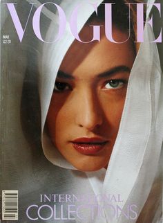 a magazine cover with a woman's face covered in white veils on the cover