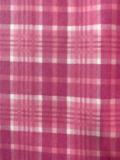 a red and white checkered fabric is shown in close up view on the surface