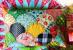 a colorful patchwork pillow is sitting on a chair with polka dots and circles around it