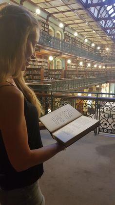 a woman holding an open book in her hands